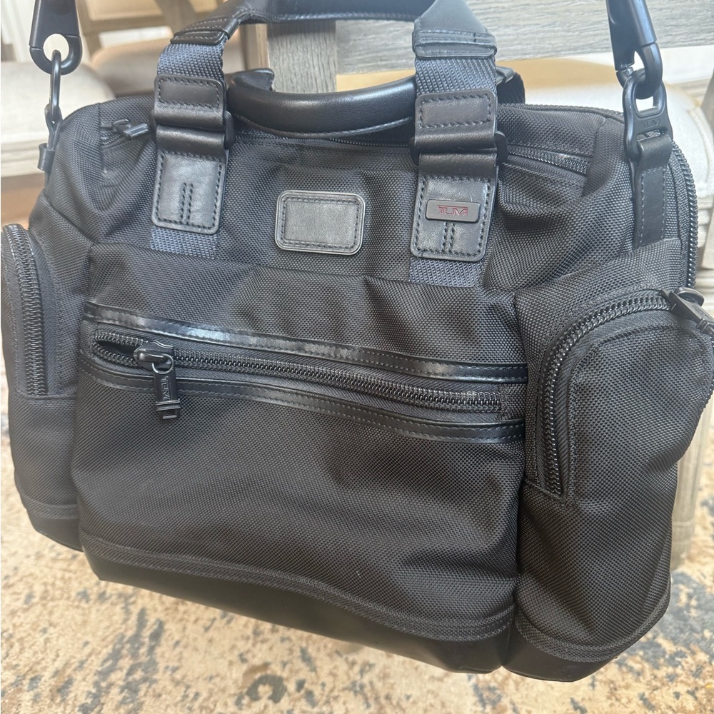 Tumi crossbody business bag.  Excellent